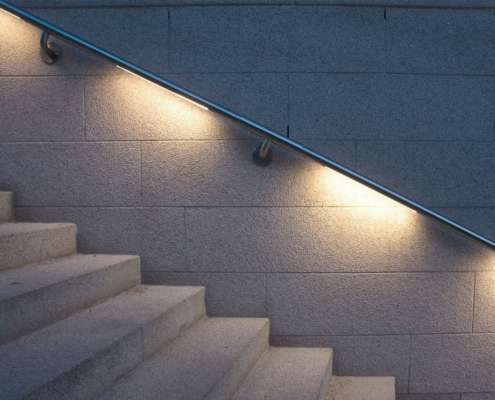 Side view of a handrail that is lit from the bottom