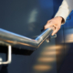 Side view of a man holding a handrail
